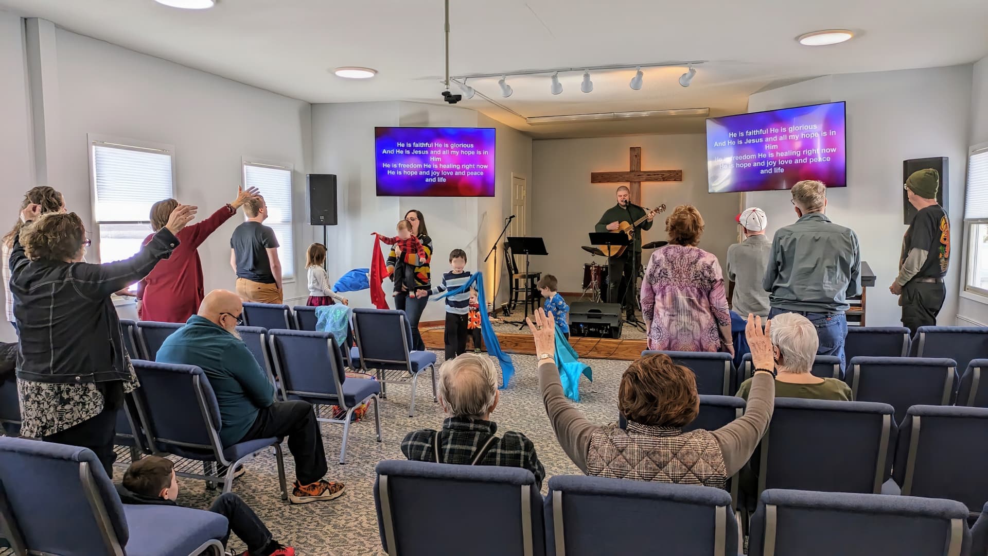 SkyWater Church kids participating with flags during worship